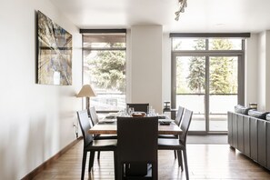 Dining area with large window walls for plenty of natural light
