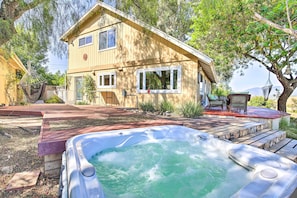 This fabulous home boasts ample outdoor space that includes a hot tub.