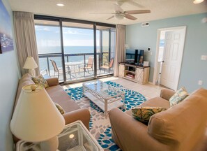 Living room with balcony and huge glass wall