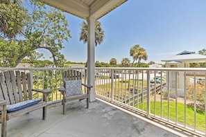 With a furnished balcony, this home offers views of soaring palm trees.