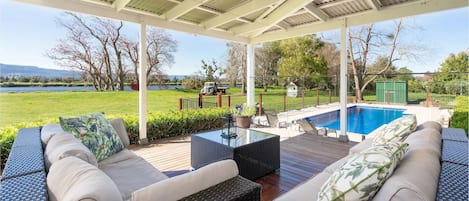 Deck overlooking inground pool and river