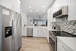 Beautiful kitchen with lots of storage and stainless steel appliances.
