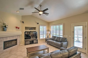 Living Room: Fireplace | Flat-Screen Smart TV | Ceiling Fan | Yard Access