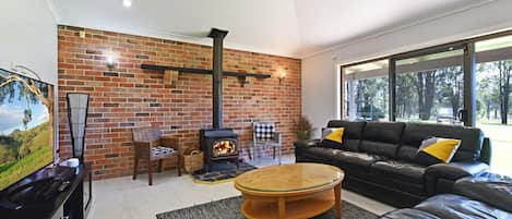 Cosy lounge room with fireplace and flat screen TV