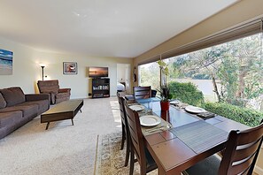 Living room / dining room with big picture windows overlooking Schwann Lagoon