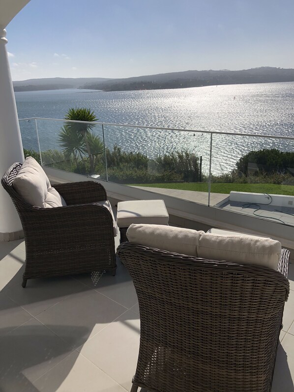 Relaxing seats for sundowners, reading  or  a board game on one Of the balconies