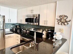 Beautiful kitchen with custom granite countertops and stainless steel appliances