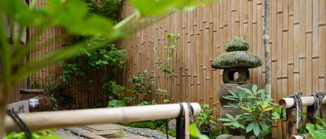 Entrance approach with stone pavement and planting