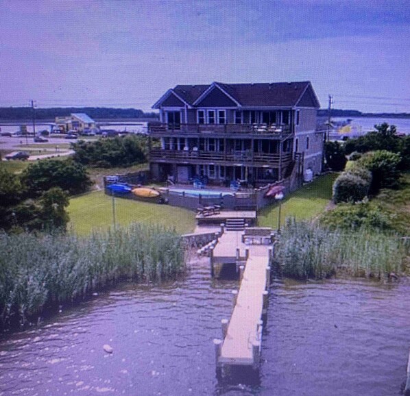 view of dock and back of house from the sound