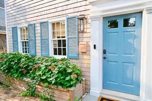 Main Entrance with Hydrangeas Flanking Door.