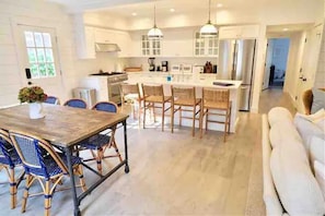 1st Floor - Custom Kitchen w/ Large Island and adjoining Dining Area 