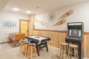 Endless fun awaits in our game room featuring air hockey, foosball, and a classic arcade! Perfect for family game nights.