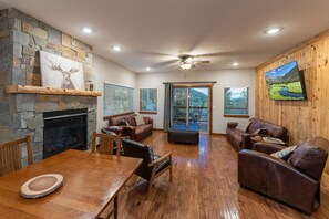 Living Room main level with ROKU 65" TV. Perfect to lounge on a quiet mountain evening.