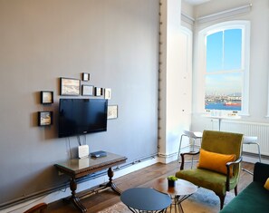 Very comfortable living space with large sofa, 2 armchairs and bar table overlooking the lovely sea views. Enjoy the smart TV here or a drink watching life on the Bosphorus below.