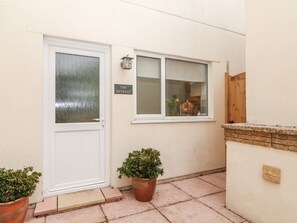 The private courtyard is accessed via a short flight of steps from the driveway.