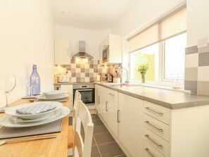 Fully-equipped kitchen with in-built wine cooler and breakfast bar.