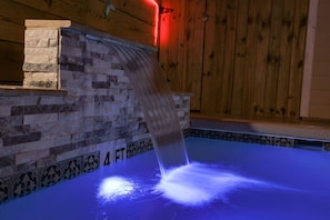 Beautiful waterfall with color changing lights in pool
