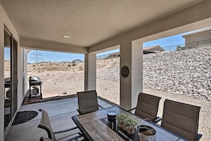 This vacation rental features an updated outdoor space with a dining table!