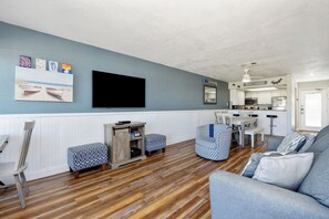 The kitchen, dining, and living areas blend seamlessly for a bright and airy feel