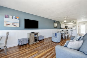 The kitchen, dining, and living areas blend seamlessly for a bright and airy feel