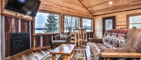 High-ceilinged living area w/ big windows to over sea the lake