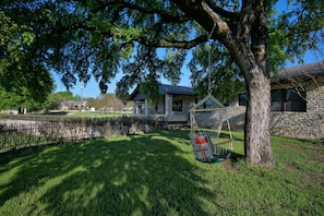 Portion of upper yard with hammock swing. 