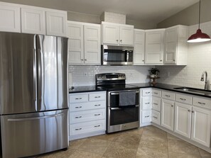 Beautiful custom kitchen with a double oven. Brand new fridge and microwave. 