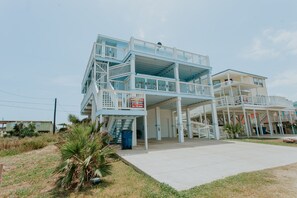 View of home from bottom drive. Home has full wrap around deck, stairs & a ramp!