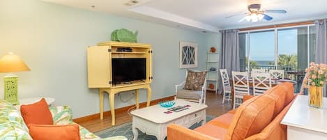 Tybee Beach Club 127 - Living room opens to balcony with a view of the ocean