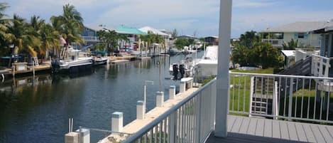 Spacious covered porch with views of 80ft wide deep water canal . 60 ft dock 