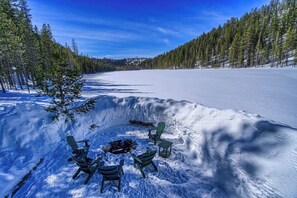 Shared fire pit at edge of lake