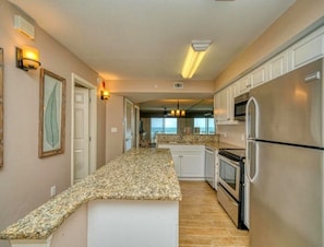 Spacious, well stocked kitchen with stainless steel appliances