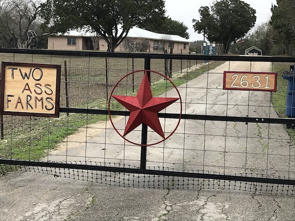 The gate welcoming you to Two Ass Farms. 