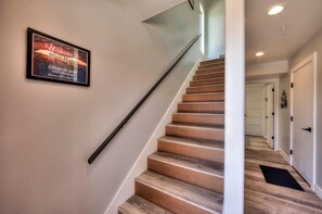Stairs to living area and hallway to garage and laundry room
