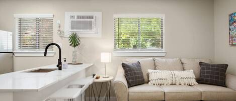 Living room with sleeper sofa and kitchen with bar seating