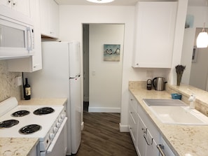 Kitchen with access to bedroom hallway