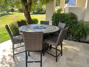 Golf course patio with fire pit table.