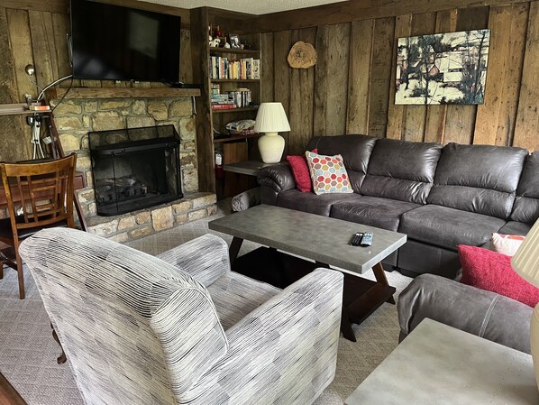 Warm fireplace centers the cozy sectional seating 