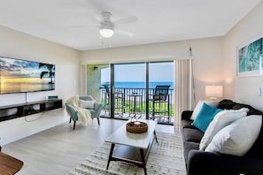 Perfect spot to unwind with ocean views and a 55” flatscreen TV for entertainment.