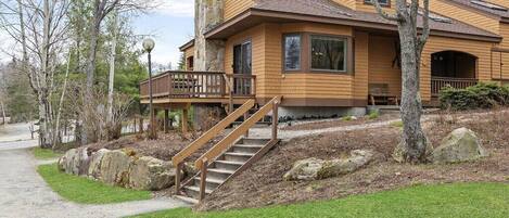 View of house from front grass abutting slope-side beginner trail