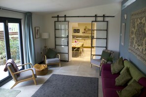 The living room area with sliding doors into the kitchen.