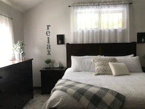 Rest in comfort in the master bedroom with a king sized bed.
