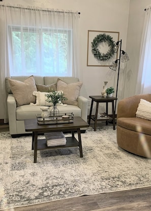 New leather couch and chair makes for a comfortable relaxing area to watch TV.