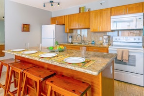 Fully equipped kitchen perfect for culinary needs with dining area.