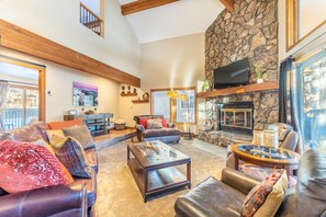 The living area features vaulted ceilings, a gas fireplace, a mounted flat screen TV and an inviting seating area.