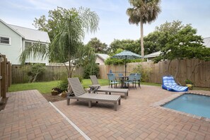 Pool area is fenced and includes a Patio table for 6 plus loungers, gas grill. 