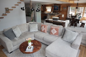 Spacious living room with oversized sofa and pellet stove