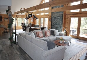 Spacious living room with oversized sofa and pellet stove