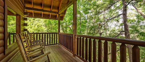 1 of 4 private decks! Back deck with wooded views and a natural gas grill.