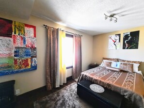 Master bedroom with beautiful original art pieces.